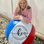 Image for Kelly's Video page where Kelly leaning on a large KEsells beach ball