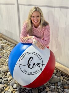 Image for Kelly's Video page where Kelly leaning on a large KEsells beach ball